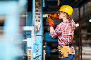 Female electrician working on a construction site.